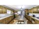 Spacious kitchen featuring wood floors, a center island and lots of cabinets at 128 Turner Ln, Bowdon, GA 30108