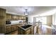 Bright kitchen showcasing a large island with seating, updated cabinets, and modern pendant lighting at 128 Turner Ln, Bowdon, GA 30108