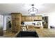 Bright kitchen featuring a large island with a sink, wood cabinets, and modern lighting at 128 Turner Ln, Bowdon, GA 30108
