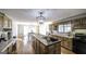 Open kitchen featuring a large island with a sink, wood cabinets, and a view of the dining area at 128 Turner Ln, Bowdon, GA 30108