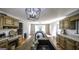 Bright kitchen featuring a sink in the island, pendant lighting, and access to the dining room at 128 Turner Ln, Bowdon, GA 30108