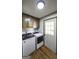Functional laundry room featuring modern washer and dryer units and storage cabinets at 128 Turner Ln, Bowdon, GA 30108