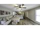 Inviting living room with stylish wood floors, large sofa, ceiling fans and stairs to the second floor at 128 Turner Ln, Bowdon, GA 30108