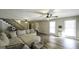 Inviting living room featuring wood floors, ceiling fans and stairs to the second floor at 128 Turner Ln, Bowdon, GA 30108