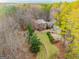 An aerial view highlights a brick home on a large lot featuring mature trees at 233 Spear Rd, Fayetteville, GA 30215