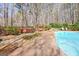 Relaxing backyard with a hot tub, wooden swing, waterfall feature, and pool, offering a tranquil outdoor experience at 233 Spear Rd, Fayetteville, GA 30215