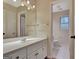 Bright bathroom features a white vanity, large mirror, and tiled floors at 233 Spear Rd, Fayetteville, GA 30215