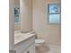 Bright bathroom featuring tiled floors, window, and white fixtures at 233 Spear Rd, Fayetteville, GA 30215