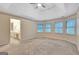 Large bedroom with tray ceiling and view into the connected bathroom at 233 Spear Rd, Fayetteville, GA 30215