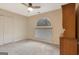 Bedroom with neutral carpet, ceiling fan, and arched window at 233 Spear Rd, Fayetteville, GA 30215