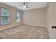 Comfortable bedroom with carpet, ceiling fan, and natural lighting at 233 Spear Rd, Fayetteville, GA 30215