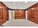 Bonus room with carpet, wood paneling, and multiple doors at 233 Spear Rd, Fayetteville, GA 30215