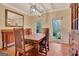 Dining room with ample natural light, hardwood floors, and a stylish light fixture at 233 Spear Rd, Fayetteville, GA 30215