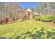 Traditional brick home boasts a well-manicured lawn and mature landscaping at 233 Spear Rd, Fayetteville, GA 30215