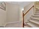 Hallway with carpeted stairs, wooden railing, and neutral paint at 233 Spear Rd, Fayetteville, GA 30215