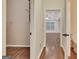 Hallway view with wood floors leading to living room and closet with shelving at 233 Spear Rd, Fayetteville, GA 30215