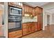 Kitchen featuring built-in oven, microwave, wooden cabinetry and tiled backsplash at 233 Spear Rd, Fayetteville, GA 30215