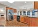 View of kitchen featuring stainless steel refrigerator, wood cabinets, and granite countertops at 233 Spear Rd, Fayetteville, GA 30215