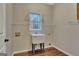 Functional laundry room featuring a utility sink, shelving, and natural light at 233 Spear Rd, Fayetteville, GA 30215