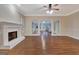 Living room with hardwood floors, fireplace, and views to sunroom at 233 Spear Rd, Fayetteville, GA 30215