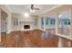 Bright living room featuring a fireplace, ceiling fan, and views to the sunroom at 233 Spear Rd, Fayetteville, GA 30215