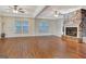 Inviting living room showcasing a stone fireplace, ceiling fans, and ample natural light at 233 Spear Rd, Fayetteville, GA 30215