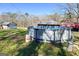 View of a backyard with an above ground pool and various sheds at 623 Swan Lake Rd, Stockbridge, GA 30281