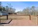 Wooden deck offering a serene view of the expansive backyard and surrounding trees at 623 Swan Lake Rd, Stockbridge, GA 30281