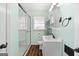 Well-lit bathroom featuring a glass-enclosed shower and modern vanity with ample storage space at 623 Swan Lake Rd, Stockbridge, GA 30281