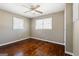 Relaxing bedroom highlighting hardwood floors, two windows, and a modern ceiling fan at 623 Swan Lake Rd, Stockbridge, GA 30281