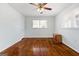 Cozy bedroom features hardwood floors, a ceiling fan, and ample natural light from the window at 623 Swan Lake Rd, Stockbridge, GA 30281