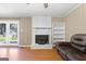 Inviting living room featuring a brick fireplace with wood-burning insert, and access to a backyard deck at 623 Swan Lake Rd, Stockbridge, GA 30281