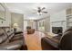 Cozy living room featuring a brick fireplace, ceiling fan, comfortable seating, and access to outdoor spaces at 623 Swan Lake Rd, Stockbridge, GA 30281