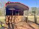 Features an open-sided shed with a red roof and wooden fencing in a natural setting at 623 Swan Lake Rd, Stockbridge, GA 30281