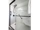 Modern walk-in shower with clear glass enclosure, seat, and sleek fixtures with a handheld shower head at 623 Swan Lake Rd, Stockbridge, GA 30281