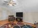 Spacious bonus room with vaulted ceiling, ceiling fan, TV, fireplace, and colorful patterned rug at 355 Parker Rd, Covington, GA 30014