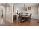 Elegant dining room featuring hardwood floors, a decorative light fixture and ample seating at 355 Parker Rd, Covington, GA 30014