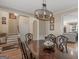 Elegant dining room featuring hardwood floors, decorative light fixture and open access to the staircase at 355 Parker Rd, Covington, GA 30014