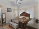 Serene main bedroom featuring hardwood floors, tray ceiling, and a large ornate bed at 355 Parker Rd, Covington, GA 30014