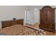 Partial view of main bedroom with hardwood floors, dresser and an open hallway to bathroom at 355 Parker Rd, Covington, GA 30014