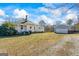 View of backyard with a detached garage, fence, and ample space at 1669 Spring Ne St, Conyers, GA 30012