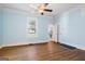 Light-filled bedroom featuring hardwood floors, soft blue walls, and an en-suite bathroom at 1669 Spring Ne St, Conyers, GA 30012