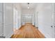 Hallway featuring hardwood floors, white walls, and doorways leading to other rooms at 1669 Spring Ne St, Conyers, GA 30012