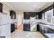 Well-lit kitchen with granite countertops, stainless steel appliances, and dark cabinets at 1669 Spring Ne St, Conyers, GA 30012