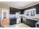 Kitchen with black cabinetry, granite countertops, and stainless steel appliances at 1669 Spring Ne St, Conyers, GA 30012