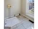 Bright laundry room features tile floors, white wainscoting, and a window providing natural light at 1669 Spring Ne St, Conyers, GA 30012