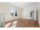 Inviting living room with hardwood floors, a window with neighborhood views, and classic architectural details at 1669 Spring Ne St, Conyers, GA 30012