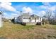 Rear exterior showing sunroom, fencing, and stone foundation at 1669 Spring Ne St, Conyers, GA 30012