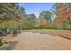 Inviting brick patio with Adirondack chairs overlooks a spacious, tree-lined backyard at 375 Darren Dr, Fayetteville, GA 30215