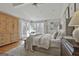 Well-lit bedroom with hardwood floors, a ceiling fan, a sitting area, and several windows at 375 Darren Dr, Fayetteville, GA 30215